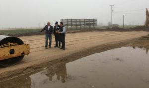 Ed and Tim Alt planning with Mark Kuperus, and discuss all the recent rain that has fallen on the job site in the past week