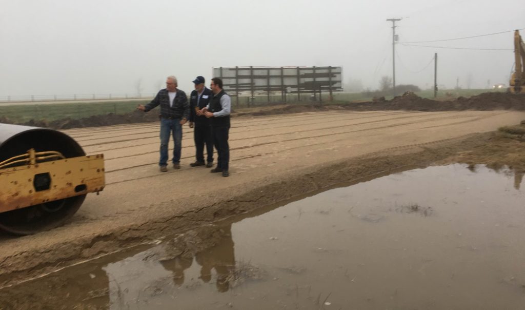 Ed and Tim Alt planning with Mark Kuperus, and discuss all the recent rain that has fallen on the job site in the past week